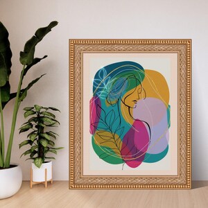 May include: Framed art print featuring a minimalist line drawing of a woman's profile, with colorful abstract shapes in teal, yellow, pink, and purple. The artwork is in a gold ornate frame, suitable for home decor.