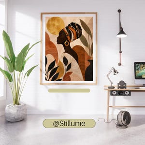 May include: A framed wall art print featuring a profile illustration of a person wearing a patterned headwrap and a large gold hoop earring. The artwork displays a warm colour palette of gold, terracotta, and black with abstract shapes and foliage.
