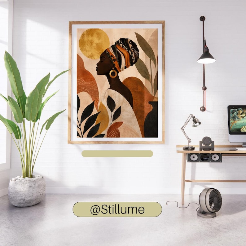 May include: A framed wall art print featuring a profile illustration of a person wearing a patterned headwrap and a large gold hoop earring. The artwork displays a warm colour palette of gold, terracotta, and black with abstract shapes and foliage.