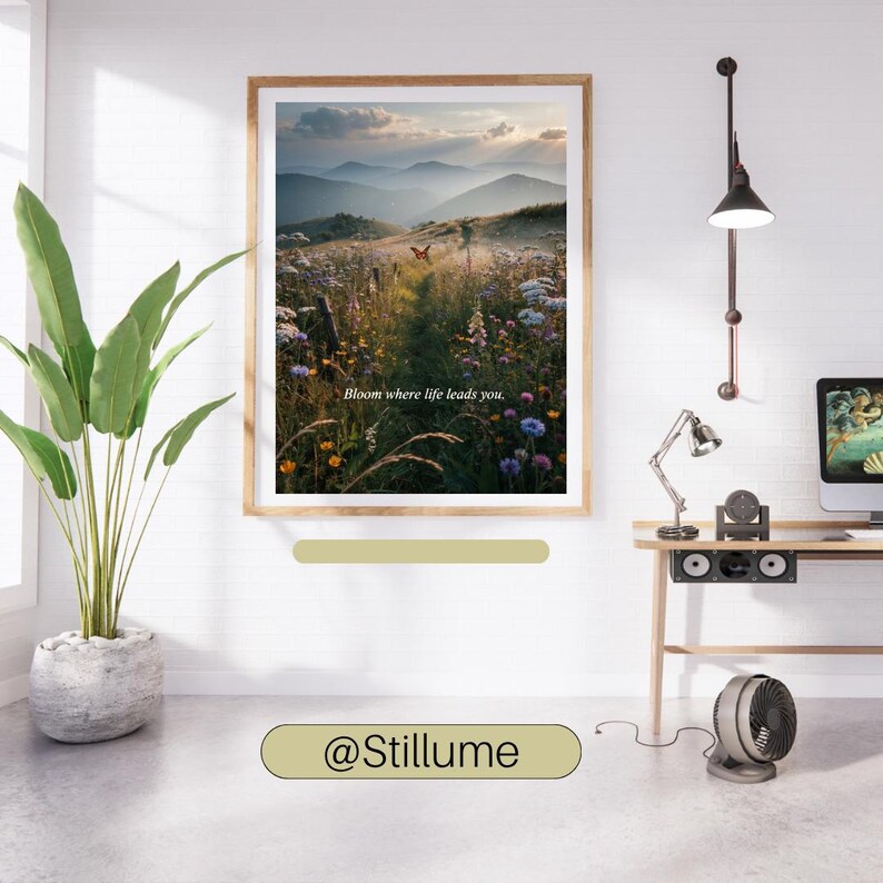 May include: A framed wall art print featuring a landscape of a wildflower meadow at sunset with distant mountains and a butterfly. The text "Bloom where life leads you." is centered in the image. The print is displayed in a wooden frame.