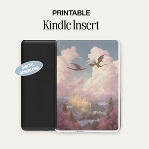 May include: A black Kindle device next to a Kindle insert with a fantasy landscape design. The insert features a castle, dragons, and a cloudy sky. Text on the insert reads "PRINTABLE Kindle Insert" and "DIGITAL DOWNLOAD".
