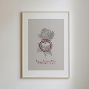 May include: Framed art print featuring a gray rose and a red ouroboros symbol. The print includes the text "In the endless circle of time, I find you again and again." The artwork is displayed in a light wood frame.