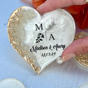 May include: Heart-shaped decorative item with gold leaf edging and a white center. The center features the initials "MA" with botanical accents and the names "Madison & Avery" with the date "22.09.24".