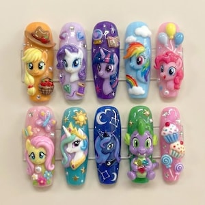 May include: A set of ten sculpted nail art designs featuring colorful My Little Pony characters. Each nail showcases a different character with intricate details, including a cowboy hat, rainbow, and cupcakes. The nails are set against a neutral background.
