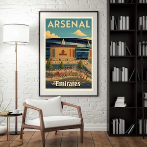 May include: Framed poster featuring the Emirates Stadium, home of Arsenal Football Club. The artwork has a vintage travel poster style, with the word "ARSENAL" at the top and "Emirates" at the bottom. The stadium is depicted with a crowd of people.