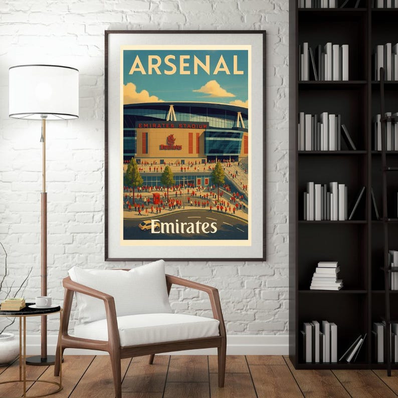 May include: Framed poster featuring the Emirates Stadium, home of Arsenal Football Club. The artwork has a vintage travel poster style, with the word "ARSENAL" at the top and "Emirates" at the bottom. The stadium is depicted with a crowd of people.