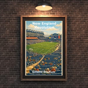 May include: Framed print of Gillette Stadium, home of the New England Revolution. The image shows a full view of the stadium with a green field, blue seating, and the text "New England Revolution" and "Gillette Stadium". The print is in a wooden frame.