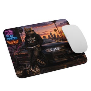 May include: A rectangular mouse pad featuring a cat wearing sunglasses and a black hoodie leaning against a black car. The background shows a city skyline at sunset with a neon sign that reads WORK HARD PLAY HARDER and a paw print logo.