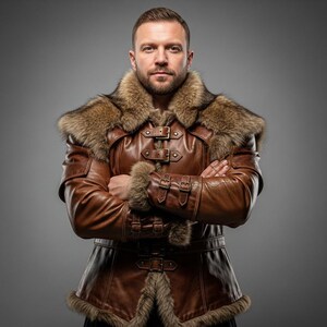 May include: A brown leather jacket with fur trim around the collar, cuffs, and hem. The jacket features multiple buckles and a belt. The person is wearing the jacket with their arms crossed.