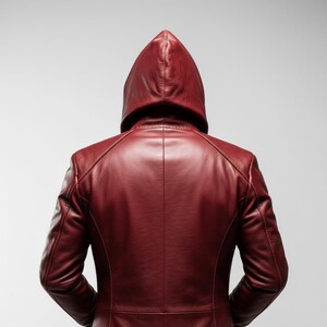 May include: A burgundy leather jacket with a hood, viewed from the back. The jacket has a tailored fit with visible stitching details along the seams. The hood is up, and the overall style suggests a modern, sleek design.