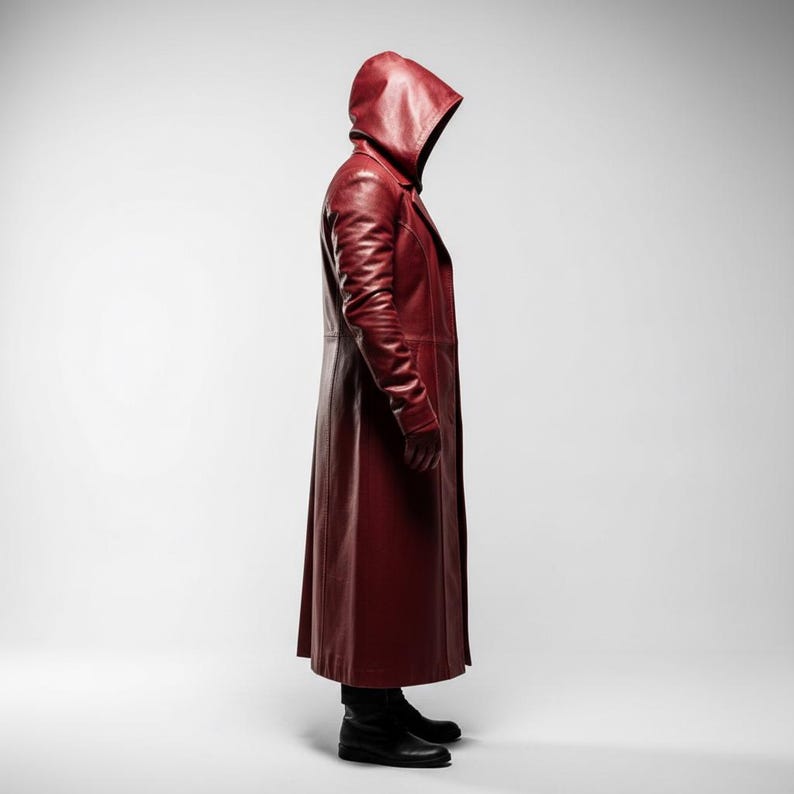 May include: A long, hooded, burgundy leather coat. The coat features a tailored fit, long sleeves, and a full-length design. The model is wearing black boots. The coat is a deep shade of red, with a glossy finish.