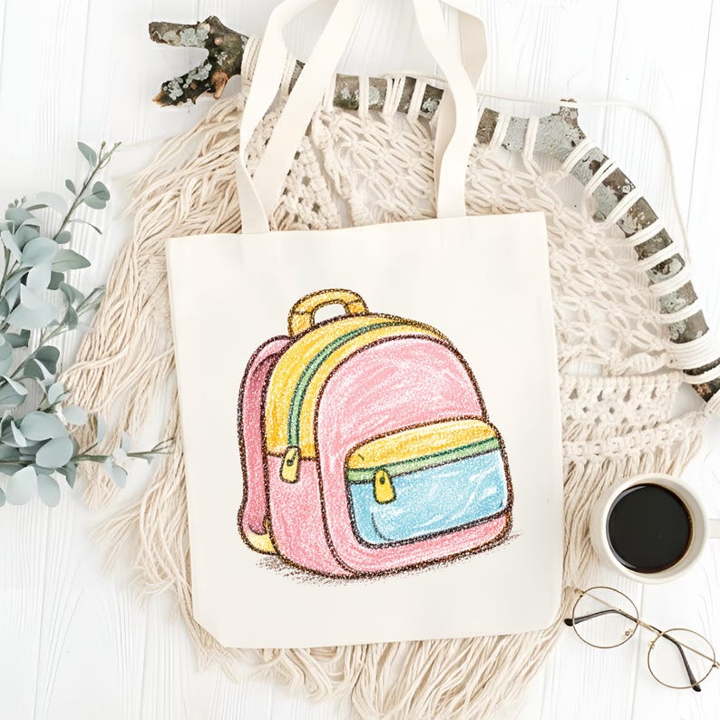 May include: A cream-colored tote bag featuring a colorful illustration of a backpack. The backpack design includes pink, yellow, and blue accents, with a yellow zipper and handle. The bag has cream-colored handles and is set against a neutral background.