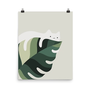 May include: A white cat with a cute face is lying on a large green leaf. The leaf has a detailed pattern and is against a light green background.