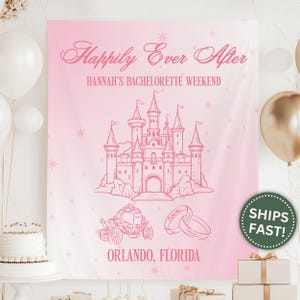 May include: A pink bachelorette party banner with the text "Happily Ever After" and "Hannah's Bachelorette Weekend." The banner features a castle illustration, a carriage, and wedding rings. The location is Orlando, Florida.