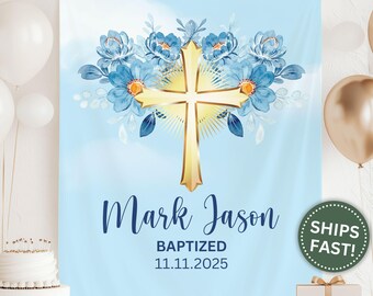 May include: A light blue baptism banner featuring a gold cross with radiating lines and blue floral accents. The banner includes the names "Mark Jason" and the date "11.11.2025" in elegant script.