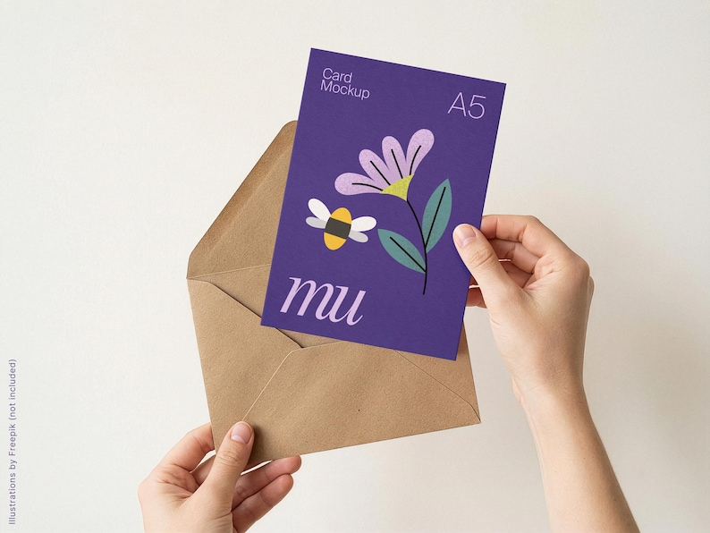 May include: A5 card mockup with a purple background featuring a flower and bee illustration, held in a brown envelope. The card has the text "Card Mockup" and "mu". The envelope is held by two hands.