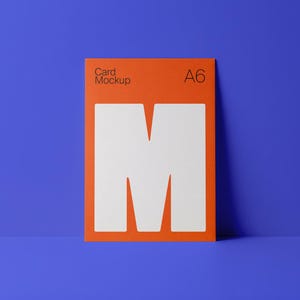May include: An orange A6 card mockup with the text "Card Mockup" and the letter "M" in white. The card is set against a blue background.