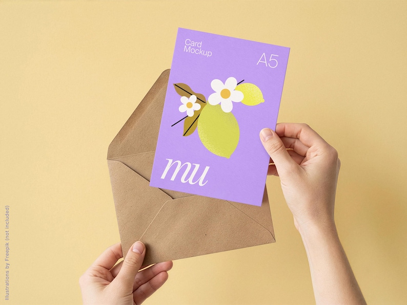 May include: A lilac A5 card mockup with a lemon and flower illustration is held above a brown envelope. The card has the word "mu" printed on it. The background is a solid yellow color.