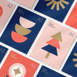 May include: A collection of A2 card mockups with geometric designs in navy blue, coral, and blush pink. The cards feature shapes like sunbursts, flowers, and trees. The words "Card Mockup" and "A2" are visible on the cards.
