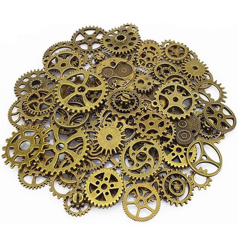 May include: A large collection of antique gold-toned metal gears of various sizes. The gears are arranged in a random pattern, creating a visually appealing and intricate design.