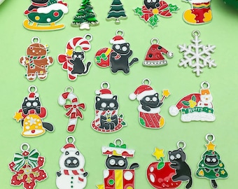May include: A collection of colorful Christmas-themed charms. The charms feature various designs, including black cats in Santa hats, Christmas trees, snowflakes, and gingerbread men. Each charm has a small loop for attaching to jewelry or other crafts.