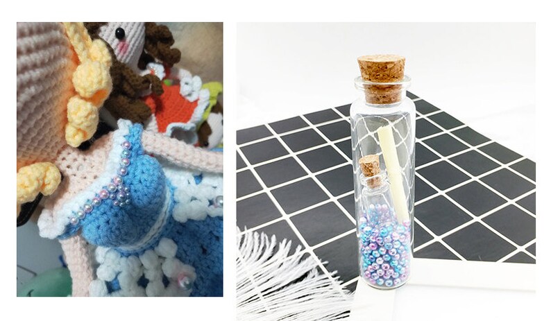 May include: Two glass bottles with cork stoppers filled with iridescent beads and a rolled up piece of paper. The bottles are on a black and white checkered surface.