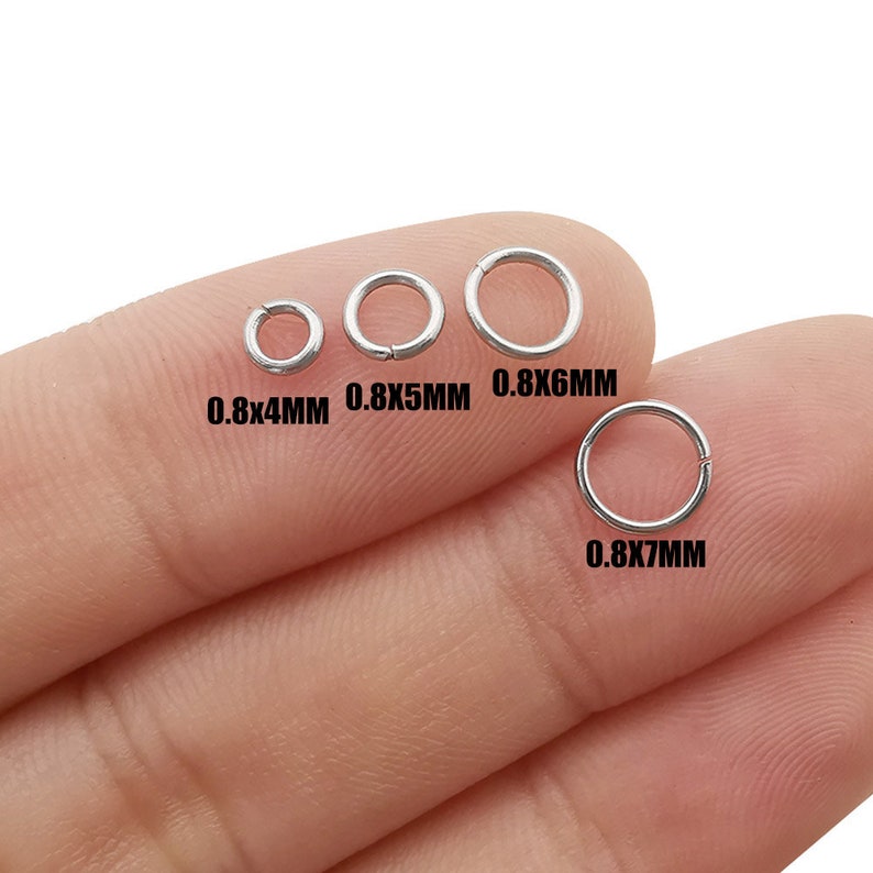 May include: Four silver jump rings of different sizes, 0.8x4mm, 0.8x5mm, 0.8x6mm, and 0.8x7mm, are shown on a finger.