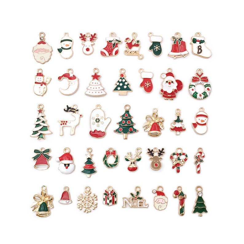 May include: Assortment of 30 gold-tone Christmas charm pendants with enamel details. The charms feature various holiday themes, including Santa Claus, reindeer, snowmen, Christmas trees, candy canes, and ornaments.