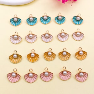 May include: Twenty gold-tone metal charms shaped like seashells with a pearl in the centre. The shells are in four colours: turquoise, pink, white, and yellow.
