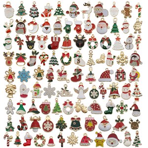 May include: Assortment of gold-tone Christmas charm pendants with various designs, including Santa Claus, reindeer, snowflakes, Christmas trees, bells, candy canes, and ornaments. The charms are colorful and feature enamel details.