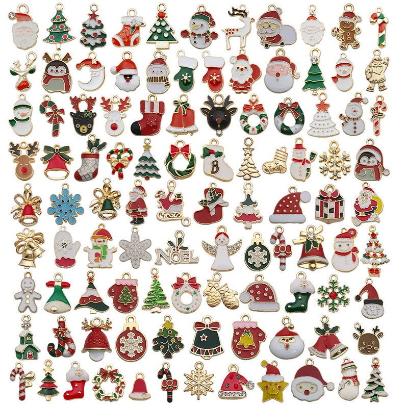 May include: Assortment of gold-tone Christmas charm pendants with various designs, including Santa Claus, reindeer, snowflakes, Christmas trees, bells, candy canes, and ornaments. The charms are colorful and feature enamel details.
