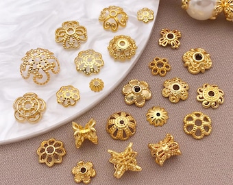 May include: A collection of gold-colored bead caps in various floral and geometric designs. The caps are in different sizes and shapes, with intricate details and openwork patterns. Some caps have a flower-like appearance, while others have a more abstract design.
