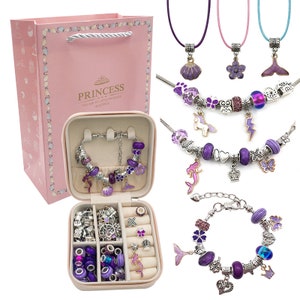May include: A purple and silver charm bracelet kit with a variety of charms, including mermaids, unicorns, crowns, and flowers. The kit comes in a pink gift box with the words "Princess You Are My Little Princess Beautiful" printed on it.