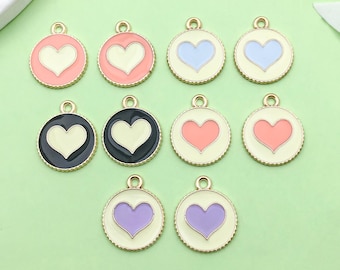 May include: Ten gold-colored metal charms with a heart design. The charms are in various colors, including pink, light blue, purple, and yellow.