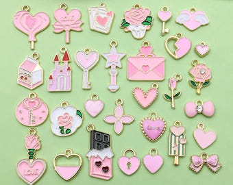 May include: Assortment of pink and gold charm pendants featuring various designs, including hearts, flowers, keys, castles, and a chocolate bar. The charms are perfect for jewelry making, scrapbooking, and other craft projects.