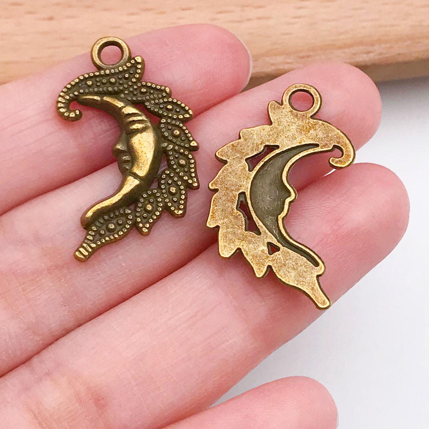 Artibetter 74 ciondoli a forma di stella di sole luna, celeste, per fai da te, per realizzare collane di Natale, bracciali e gioielli (tonalità bronzo argento