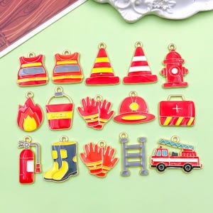 May include: A selection of firefighter-themed charms in red, yellow, and grey. The charms depict a fire engine, fire hydrant, fire boots, fire extinguisher, fire, gloves, and a first aid kit. Ideal for jewellery making or crafting projects.