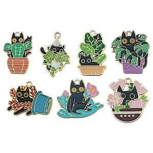 May include: Set of seven black cat charms with gold accents. Each charm features a black cat in a different plant setting, including a cactus, hanging plant, potted plant, and a cat floating on a blue wave.