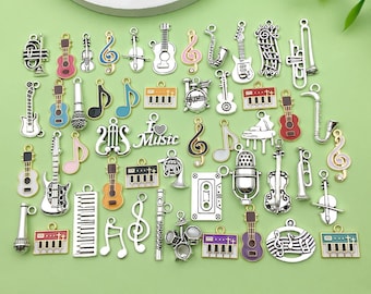 May include: A collection of silver charm pendants featuring musical instruments, notes, and other music-themed designs. The charms are colorful and include a guitar, piano, trumpet, violin, microphone, and more.
