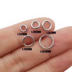 May include: Five silver jump rings of different sizes. The rings are labeled with their measurements in millimeters: 1.2x5mm, 1.2x6mm, 1.2x7mm, 1.2x8mm, and 1.2x10mm.