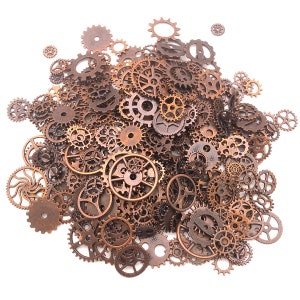 May include: A large collection of antique bronze-colored gears and cogs of various sizes, scattered on a white background.