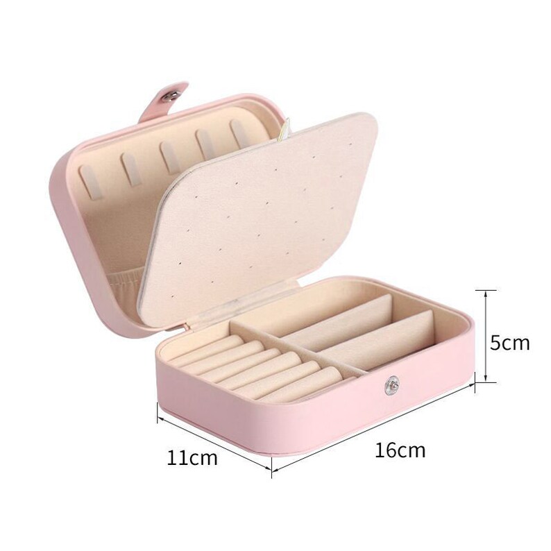 May include: A pink jewellery box with a hinged lid and multiple compartments for storing rings and earrings. The box measures 16cm by 11cm by 5cm.