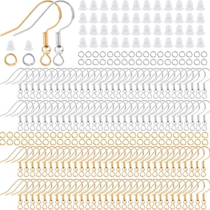 May include: A set of 100 earring hooks, including 50 gold-toned and 50 silver-toned hooks. The hooks are made of metal and have a small loop at the top. There are also 100 clear earring backs included in the set.
