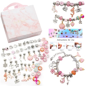 May include: A pink and silver charm bracelet kit with a variety of charms, including a unicorn, mermaid, camera, crown, and flower. The kit also includes a pink box, instructions for use, and a silver chain.
