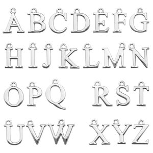 May include: Silver alphabet letter charms with a loop for hanging. The letters are in a classic serif font.  The letters are A through Z.
