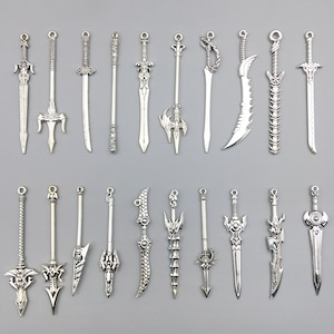 May include: A collection of 20 silver-toned sword charms. The charms are detailed and intricate, with various designs and styles. They are perfect for adding a touch of fantasy to jewelry or crafts.