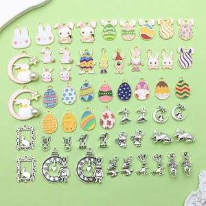 May include: Assortment of silver and gold-toned metal charms featuring Easter-themed designs.  The charms include bunnies, eggs, gnomes, and moons.  Some charms are decorated with colorful enamel paint.  The charms are perfect for adding a festive touch to jewelry, crafts, and other projects.