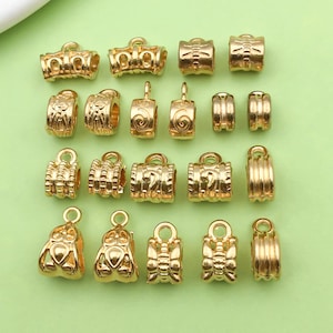 May include: A collection of 18 gold-tone metal bead caps with various designs, including swirls, butterflies, and geometric patterns. These caps are ideal for adding a touch of elegance to jewellery projects.