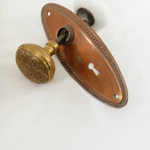 May include: A set of three ceramic mugs with a speckled, matte finish. The mugs are in shades of cream, light gray, and dark gray. Each mug has a simple, minimalist design, perfect for coffee or tea.