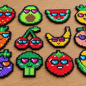 May include: A collection of twelve colorful fuse bead designs shaped like various fruits and vegetables, including a strawberry, avocado, watermelon, pineapple, carrot, cherries, banana, peach, eggplant, broccoli, tomato, and corn, all wearing sunglasses.
